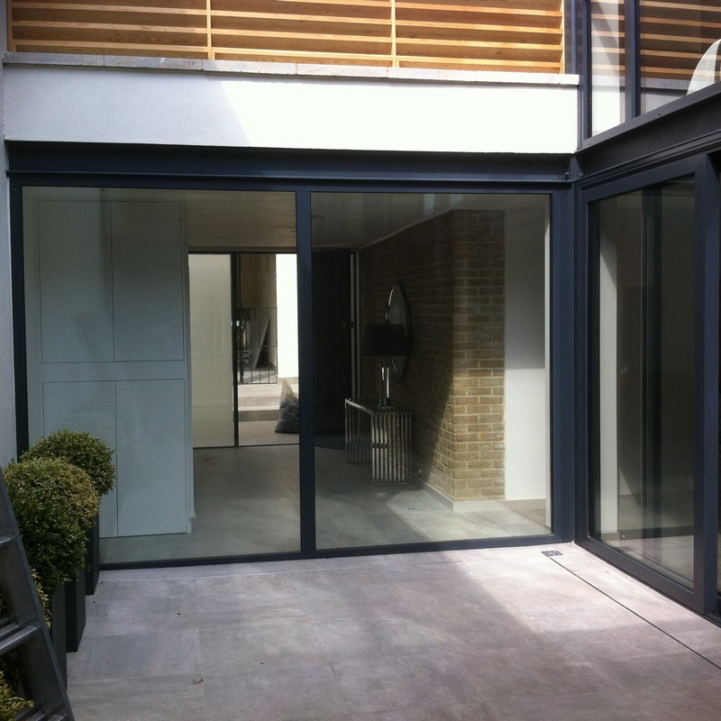 Floor-to-ceiling sliding doors opening to courtyard in Crouch End