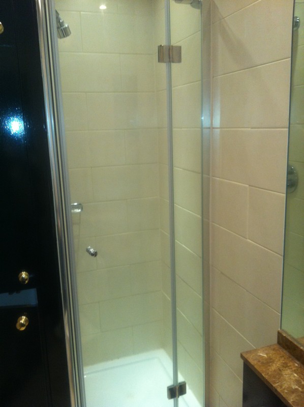 Frameless glass shower enclosure with chrome fittings in Crouch End